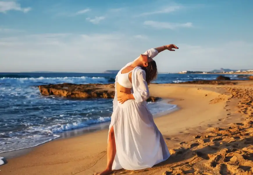 Frau macht Yoga am Strand von Mallorca