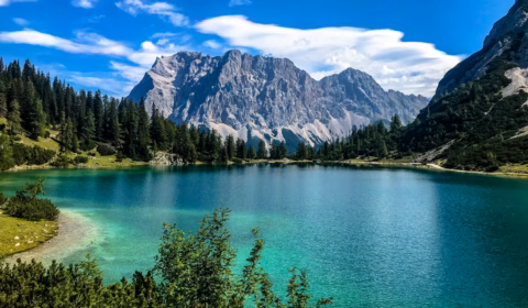 Glacial lake and mountains under blue sky