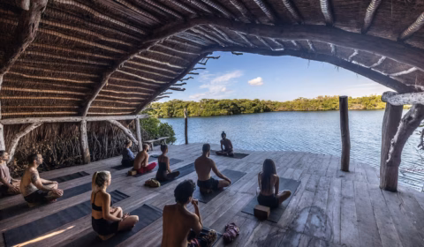 a group of people sitting on top of a wooden floor