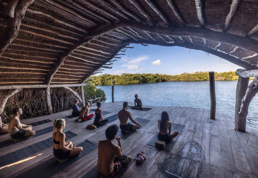 a group of people sitting on top of a wooden floor