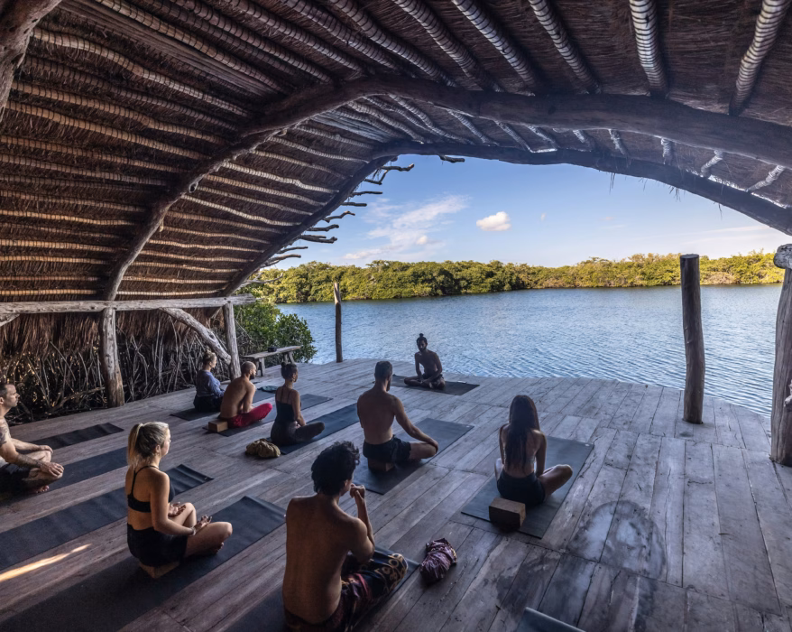 a group of people sitting on top of a wooden floor