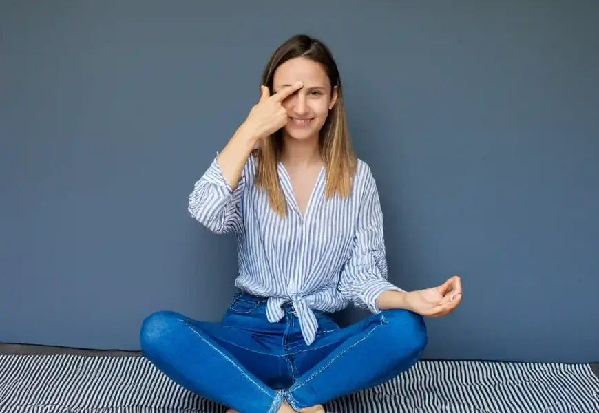 Frau hält sich das dritte Auge